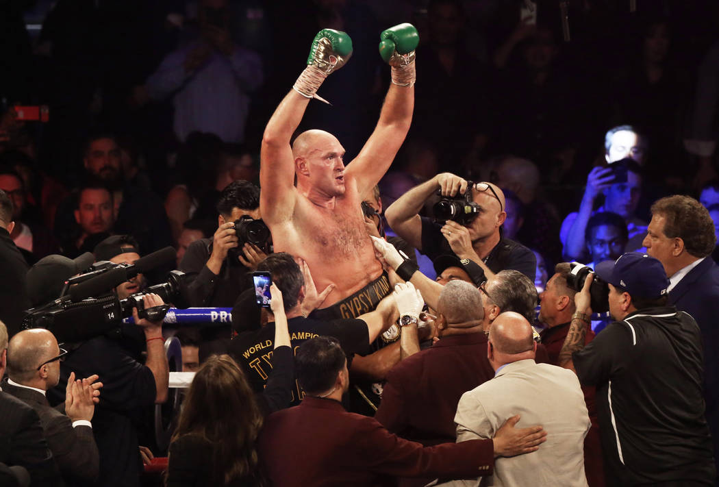 Tyson Fury celebrates after beating Deontay Wilder in the seventh round during their WBC heavyw ...
