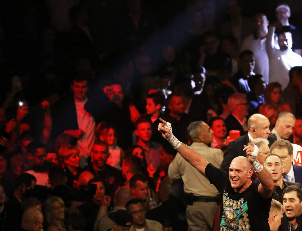 Tyson Fury, bottom/right, celebrates after beating Deontay Wilder in the seventh round during t ...
