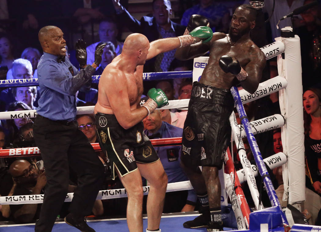 Tyson Fury lands a left hook against Deontay Wilder seconds before the fight was called in the ...