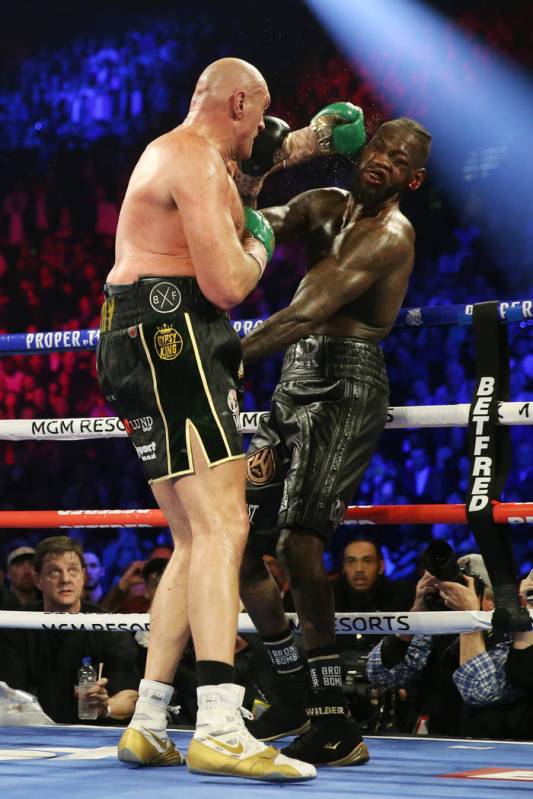 Tyson Fury connects a punch against Deontay Wilder in round 6 of the WBC world heavyweight cham ...