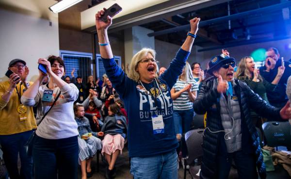 Crowd members cheer as Democratic presidential candidate and former South Bend, Ind., Mayor Pet ...