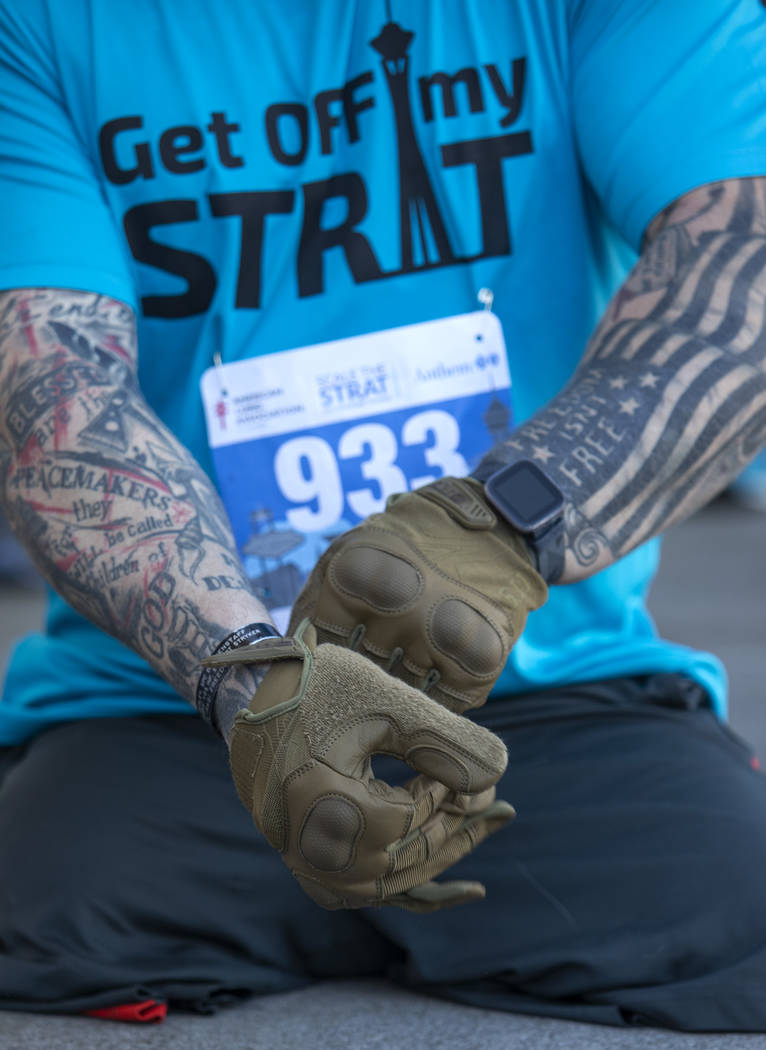 Travis Strong, a double amputee who lost both of his legs in Baghdad, puts on gloves to protect ...