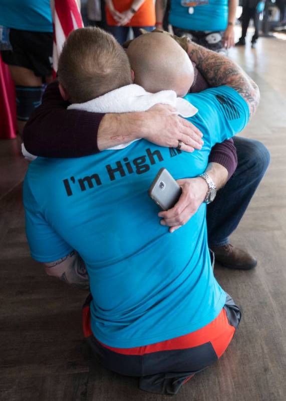Travis Strong hugs his brother after climbing all 1,455 stairs at the Strat to support the Amer ...