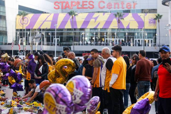 Fans gather to pay their respects at a memorial for Kobe Bryant in front of Staples Center, pri ...