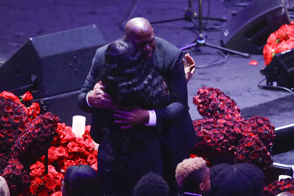 Former Los Angeles Lakers' Magic Johnson hugs Pam Bryant mother of Kobe Bryant during a celebra ...