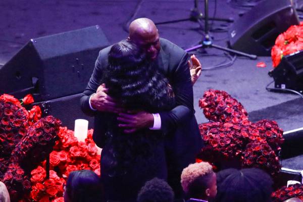 Former Los Angeles Lakers' Magic Johnson hugs Pam Bryant mother of Kobe Bryant during a celebra ...