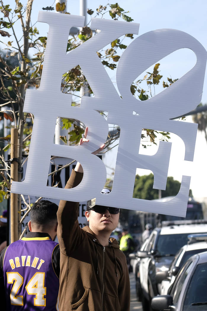 A fan holds a sign near the Staples Center before a public memorial for former Los Angeles Lake ...