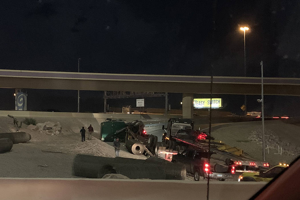 Police investigate a semitrailer rollover Monday, Feb. 24, 2020, on a ramp connecting U.S. High ...