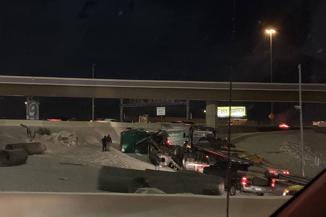 Police investigate a semitrailer rollover Monday, Feb. 24, 2020, on a ramp connecting U.S. High ...