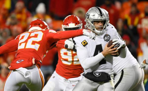 Oakland Raiders quarterback Derek Carr (4) is pressured by Juan Thornhill during the second hal ...