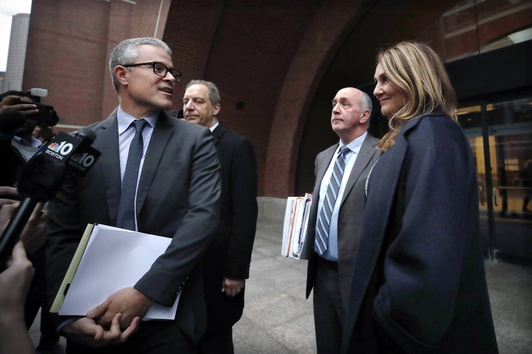 Attorney John Littrell, left, speaks to the media as client Michelle Janavs, right, stands besi ...