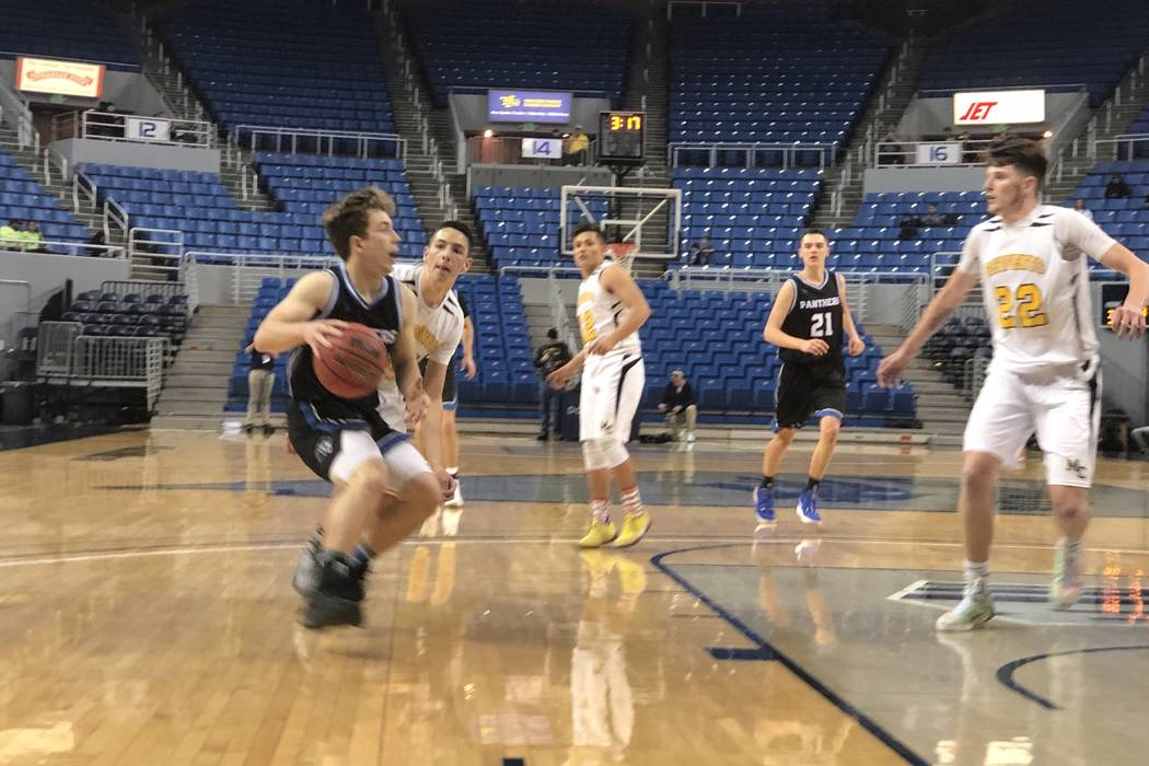 Pahranagat Valley senior guard John Hansen attacks the basket in the fourth quarter of a 50-38 ...