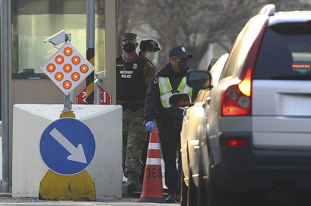 In this Thursday, Feb. 20, 2020 photo, a U.S. military policeman and South Korean security pers ...