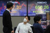 Currency traders work at the foreign exchange dealing room of the KEB Hana Bank headquarters in ...