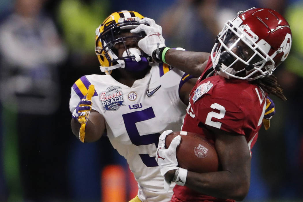 Oklahoma wide receiver CeeDee Lamb (2) runs against LSU cornerback Kary Vincent Jr. (5) during ...