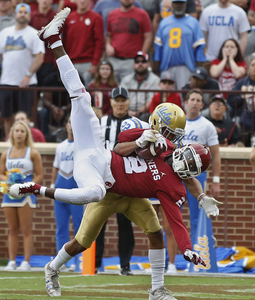 Oklahoma wide receiver CeeDee Lamb (2) comes down with a touchdown pass in front of UCLA defens ...