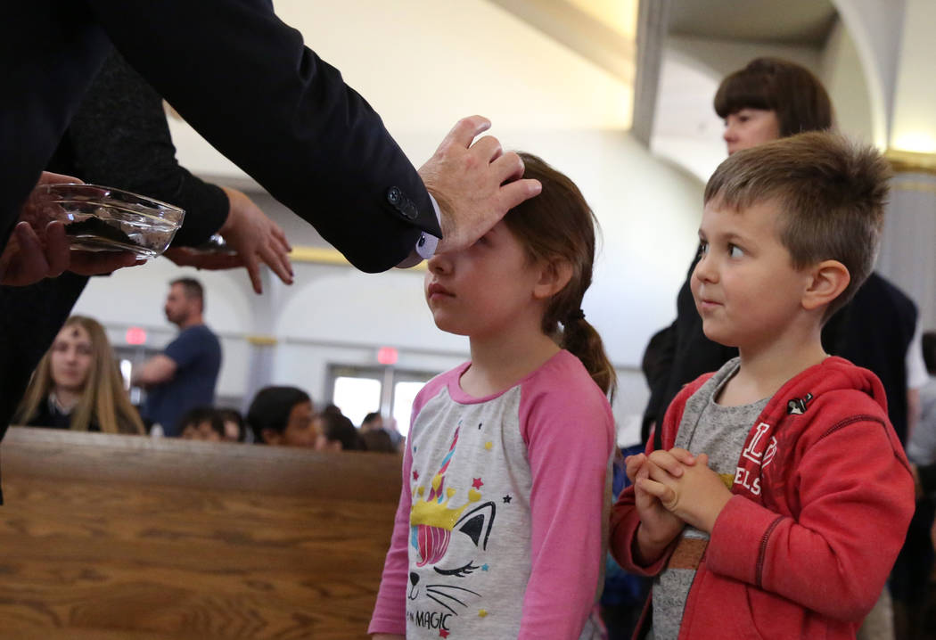 Michael Lepoie, 4, right, a pre-K student at St. Viator Catholic School, watches as his classma ...