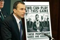 Raymond Duda, FBI Special Agent in Charge in Seattle, speaks as he stands next to a poster that ...