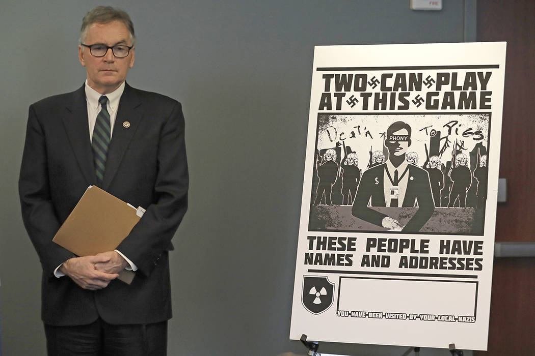 U.S. Attorney Brian Moran stands next to a poster that was mailed earlier in the year to the ho ...