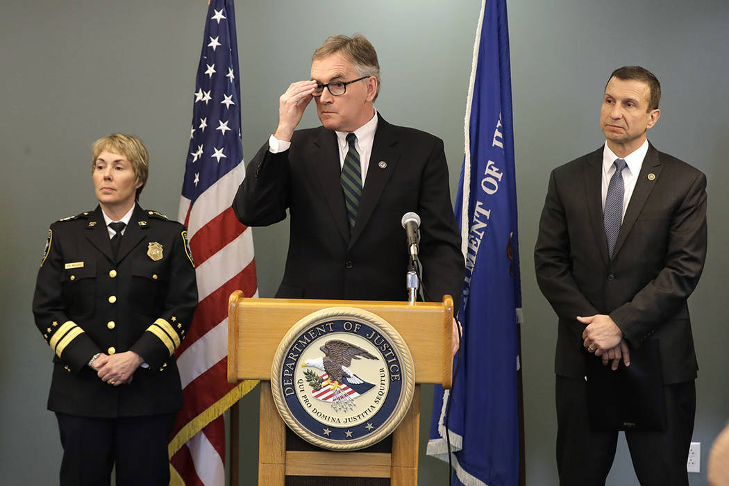 U.S. Attorney Brian Moran, center, is flanked by Seattle assistant chief of police Deanna Nolle ...