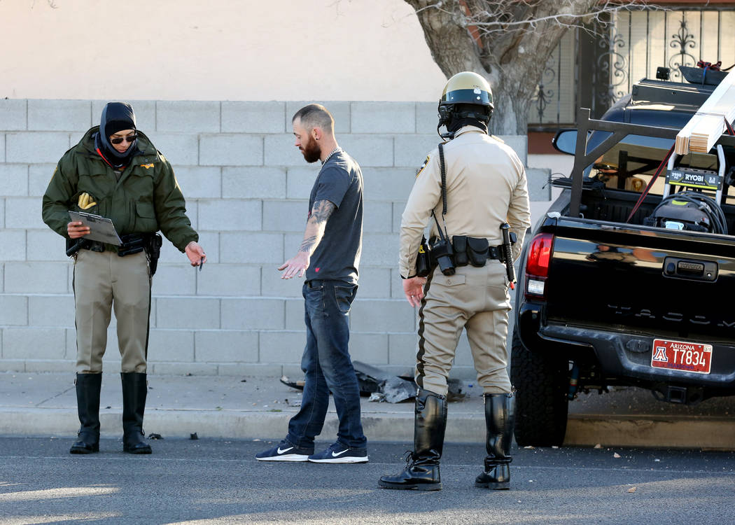 Las Vegas police officers conduct a field sobriety test after a suspected drunk driver crashed ...