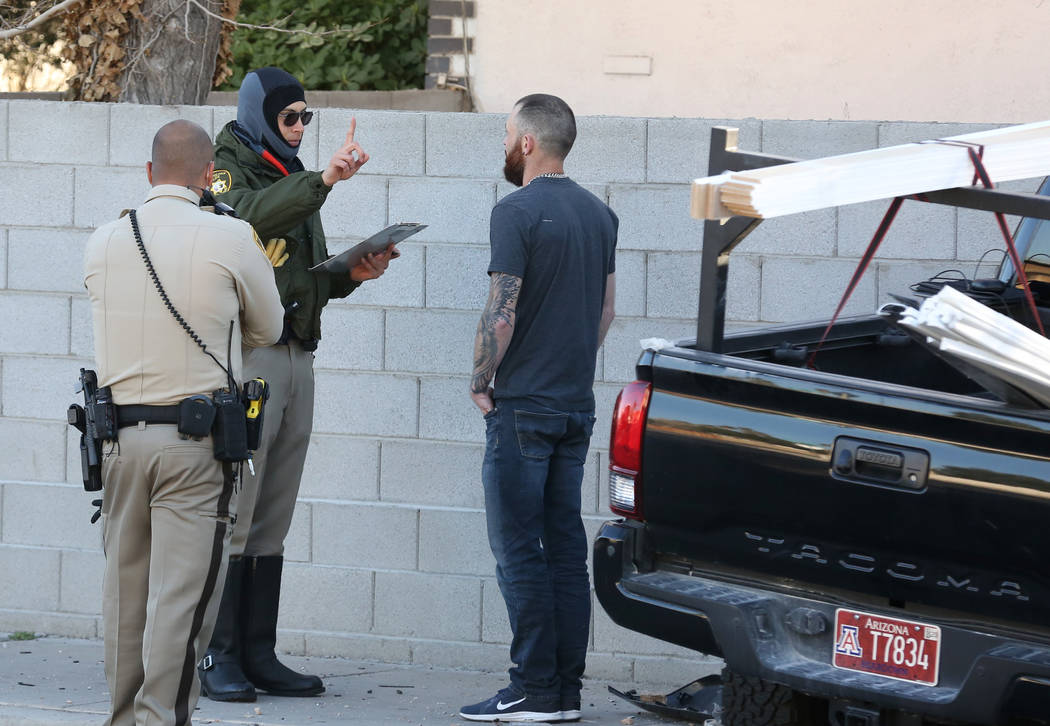 Las Vegas police officers conduct a field sobriety test after a suspected drunk driver crashed ...