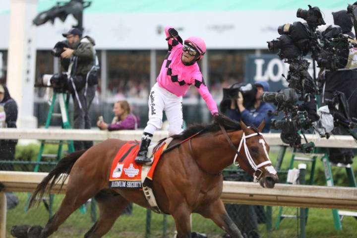 Luis Saez rides Maximum Security, and celebrates after crossing the finish line first during th ...