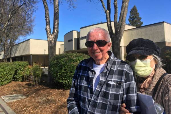 Eugenia Kendall, right, wears a mask outside of the Vacaville City Hall while standing with her ...