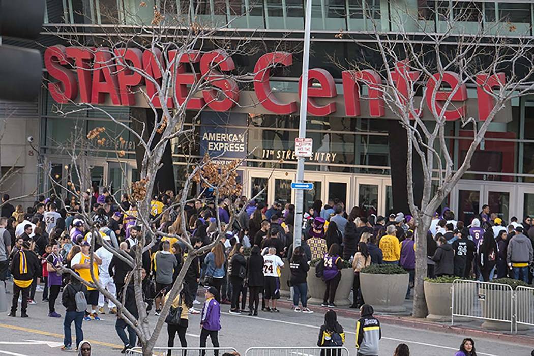 Fans line up to get into the Staples Center to attend a public memorial for former Los Angeles ...