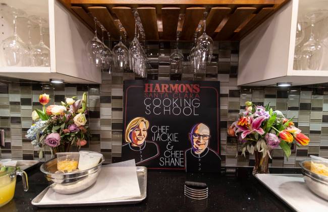 A sign bearing portraits of Harmons Cooking School chefs Jackie Dodart and Shane Robillard was ...
