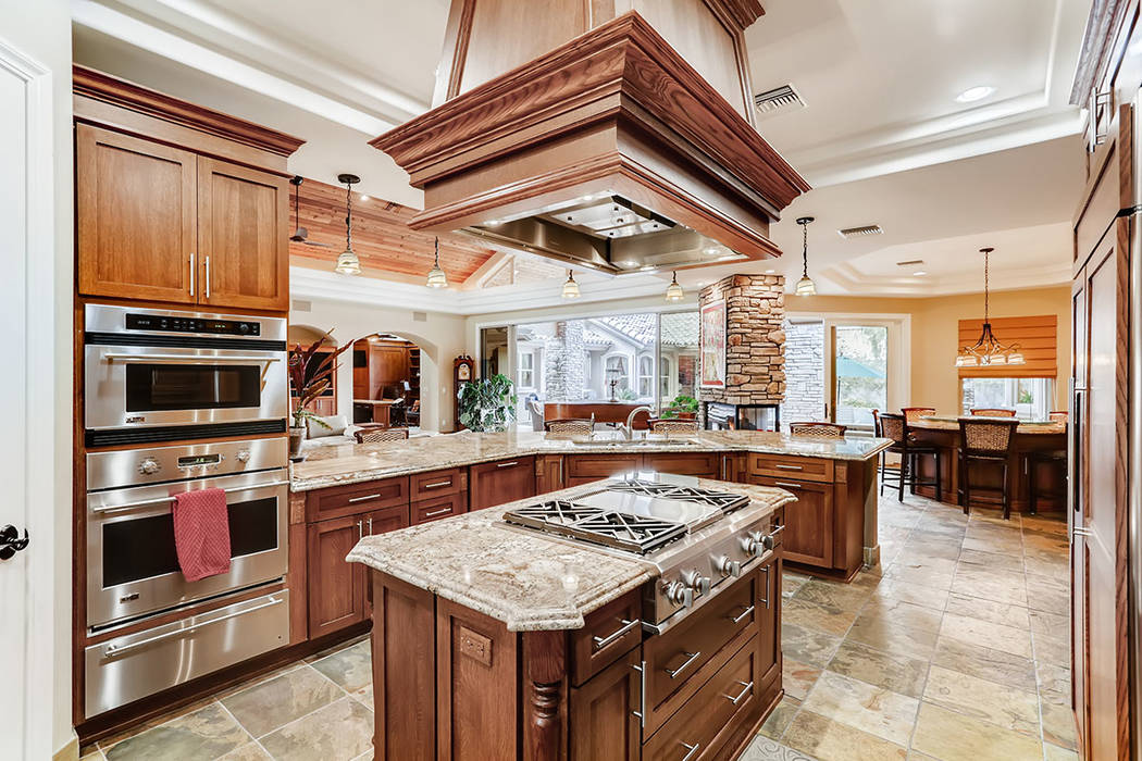 The kitchen features a large center island with granite countertop and gas cooktop. (Berkshire ...