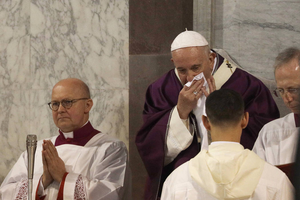 In this picture taken Wednesday, Feb. 26, 2020, Pope Francis wipes his nose during the Ash Wedn ...