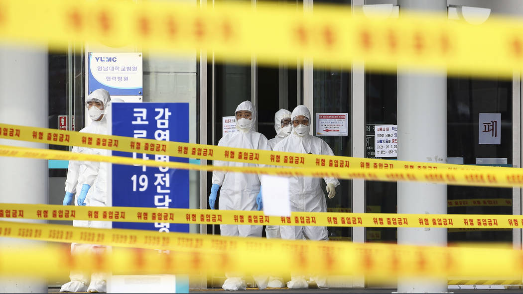 Medical staff wearing protective suits outside a hospital in Daegu, South Korea, Sunday, March ...