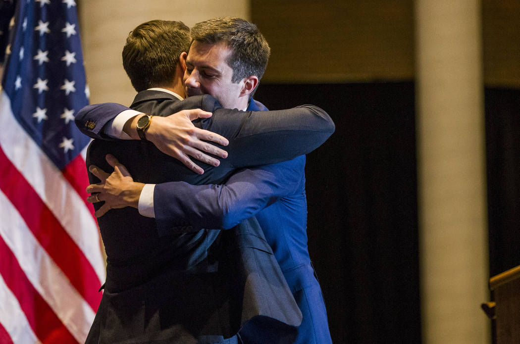 Pete Buttigieg, right, hugs his husband, Chasten Buttigieg, before ending his presidential camp ...