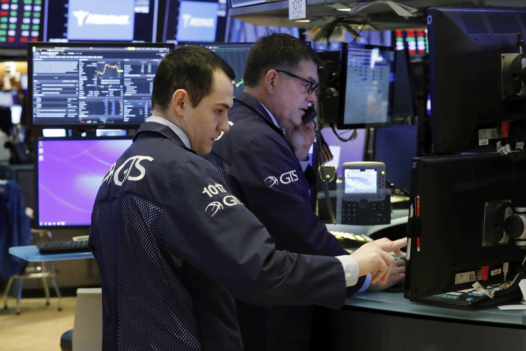 A pair of specialists prepare for the day's trading activity on the floor of the New York Stock ...