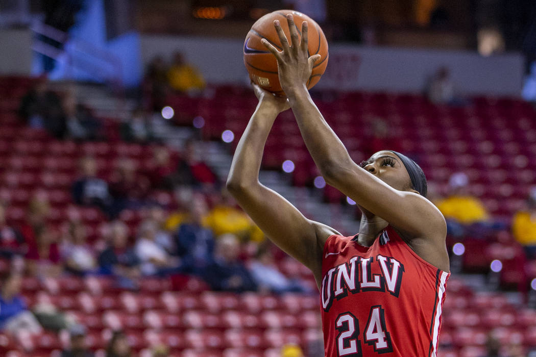 UNLV Lady Rebels guard Rodjanae Wade (24, center) catches some air as she sets up a shot past S ...