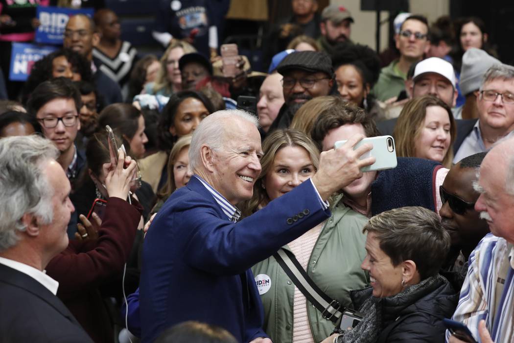 Democratic presidential candidate former Vice President Joe Biden takes photos with supporters ...