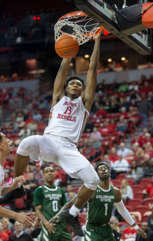 UNLV Rebels guard Bryce Hamilton (13) dunks over Colorado State Rams guard Kris Martin (1) and ...