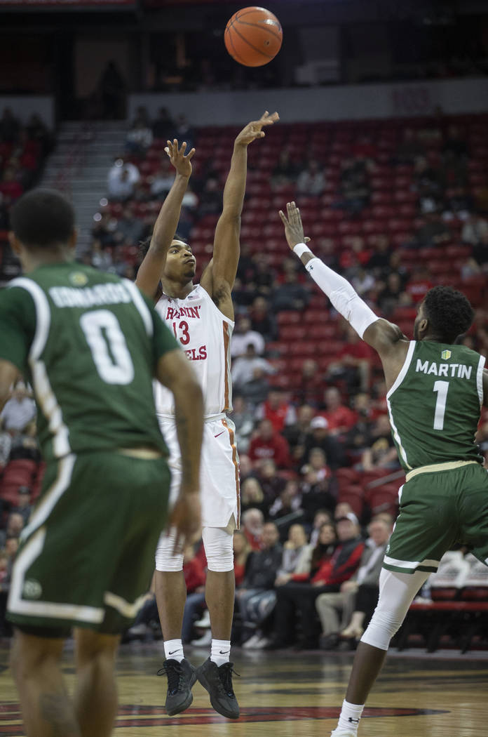 UNLV Rebels guard Bryce Hamilton (13) shoots a three point shot over Colorado State Rams guard ...