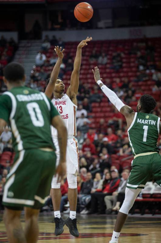 UNLV Rebels guard Bryce Hamilton (13) shoots a three point shot over Colorado State Rams guard ...