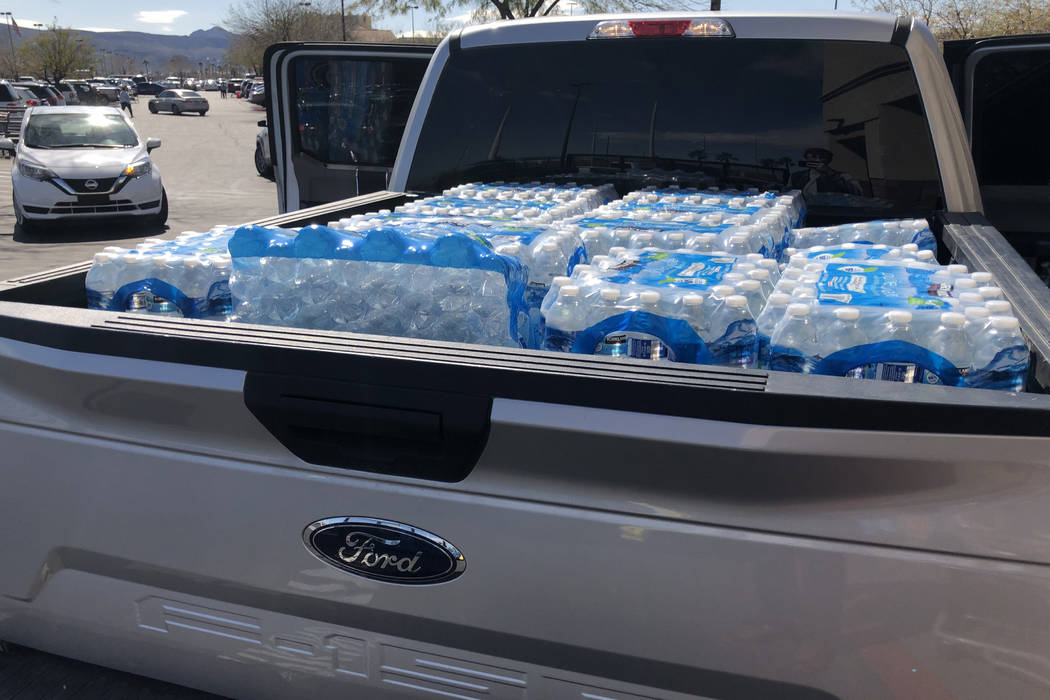 Cases of water are loaded into a truck at Costco Wholesale in Henderson on Monday, March 2, 202 ...