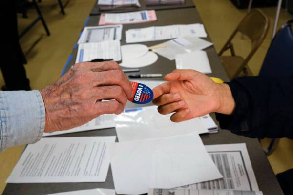 Early voter receives his I-Voted sticker, at an early voting polling station at the Ranchito Av ...
