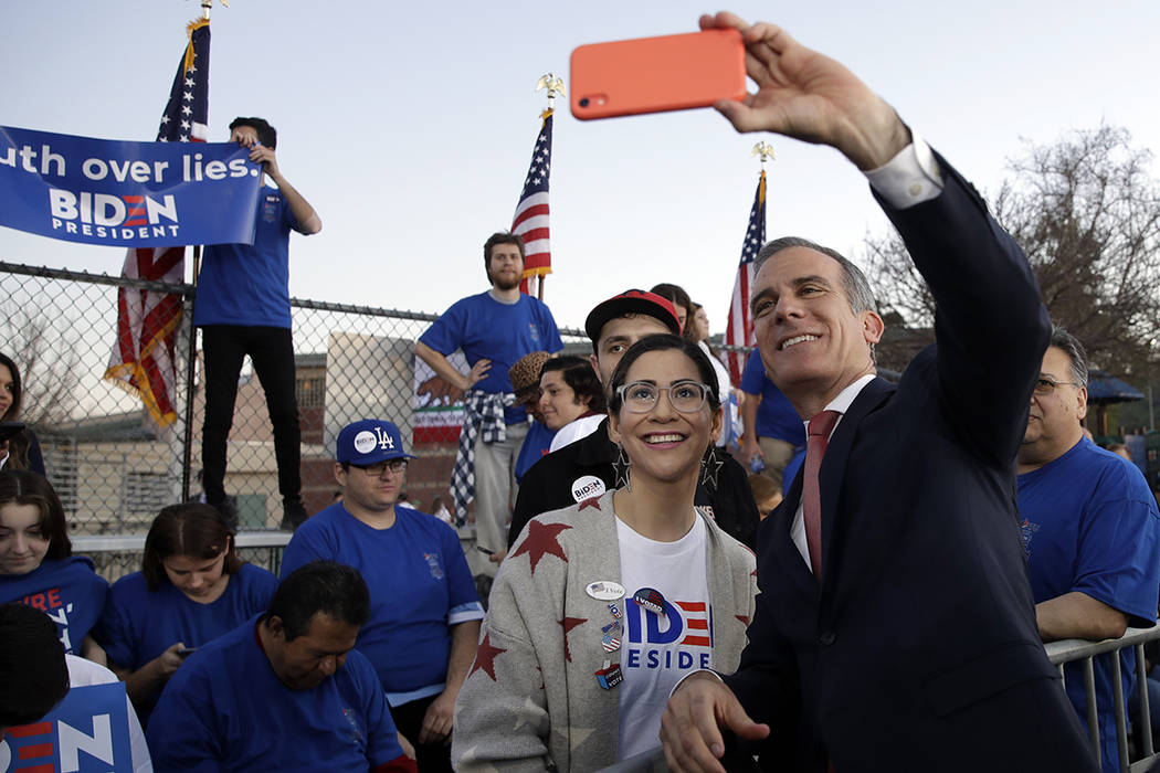 Los Angeles Mayor Eric Garcetti takes photos with people before a campaign rally for Democratic ...