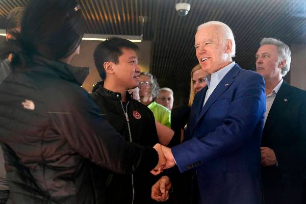 Democratic presidential candidate former Vice President Joe Biden shakes hands with customers a ...