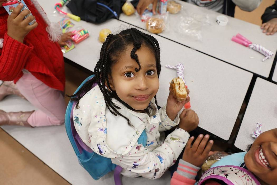 Ketty Dinkinou, 5, eats her cinnamon roll duirng the Clark County School District's first day o ...