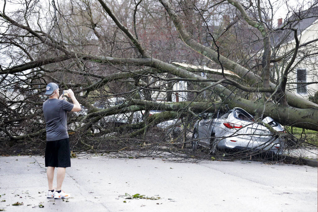 A resident photographs damage after a tornado touched down Tuesday, March 3, 2020, in Nashville ...