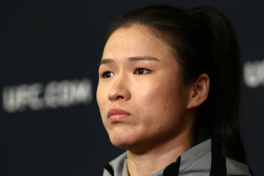 UFC strawweight champion Zhang Weili listens to questions during a news conference at the UFC A ...