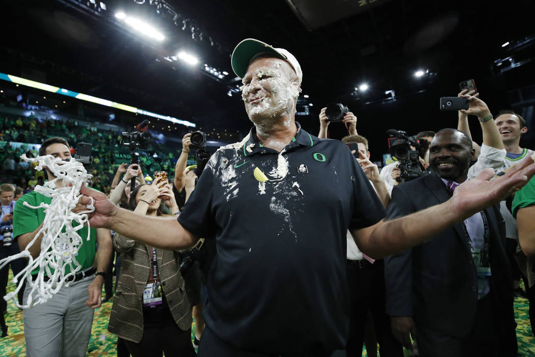 Oregon head coach Kelly Graves reacts while covered in cupcake frosting after defeating Stanfor ...