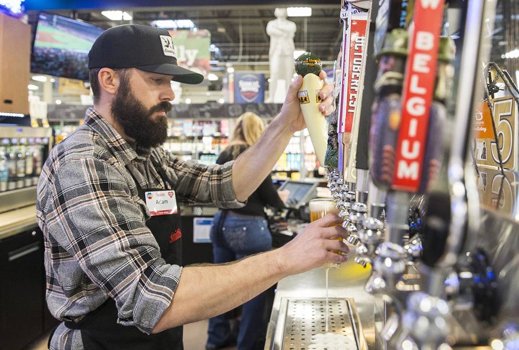 Bartender Adam Karli pours a beer at Social Hour Beer and Wine Bar on Thursday, Oct. 10, 2019, ...