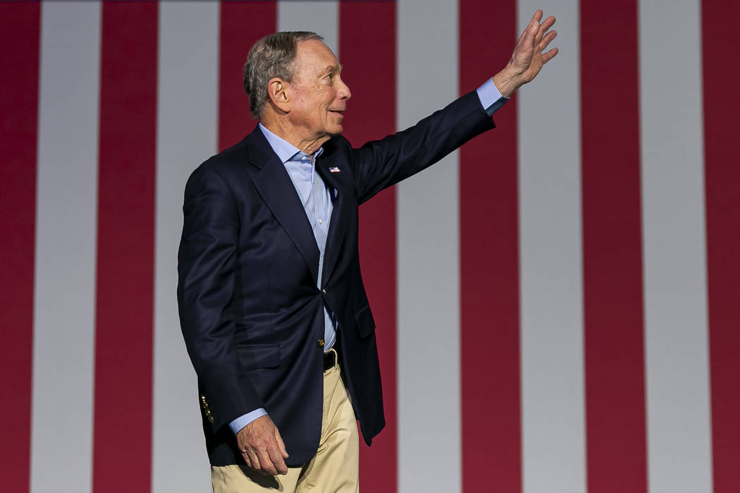 Democratic presidential candidate Mike Bloomberg waves to supporters as he arrives to his campa ...